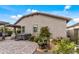 Exterior shot of a house showcasing a hot tub, patio, manicured landscaping, and serene outdoor setting at 5831 N 196Th Ln, Litchfield Park, AZ 85340
