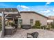 Backyard view highlighting a built-in BBQ, hot tub, elegant landscaping, and a comfortable outdoor lounge area at 5831 N 196Th Ln, Litchfield Park, AZ 85340