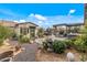 Spacious backyard with BBQ, hot tub, decorative gravel, and lush plantings, ideal for outdoor living at 5831 N 196Th Ln, Litchfield Park, AZ 85340