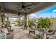 A furnished and decorated backyard with a shaded pergola area, a lawn, and foliage at 5831 N 196Th Ln, Litchfield Park, AZ 85340