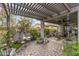 Back patio area of a home with a shaded seating area, a fan, and a stone tile floor at 5831 N 196Th Ln, Litchfield Park, AZ 85340