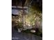 Cozy backyard patio at night, featuring ambient lighting, comfortable seating, and lush plantings for intimate gatherings at 5831 N 196Th Ln, Litchfield Park, AZ 85340