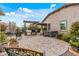 Expansive backyard with outdoor kitchen, hot tub, neutral stucco, and landscaped accents at 5831 N 196Th Ln, Litchfield Park, AZ 85340