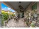 Inviting covered patio featuring stylish wicker furniture, ceiling fans, and serene outdoor living space at 5831 N 196Th Ln, Litchfield Park, AZ 85340