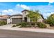 Lovely single-story home with stone accents and lush front yard landscaping at 5831 N 196Th Ln, Litchfield Park, AZ 85340