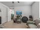 A view of a carpeted flex room with a couch, television, decorations and a workout trampoline at 5831 N 196Th Ln, Litchfield Park, AZ 85340