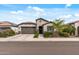 Charming home with a well-manicured lawn, mature landscaping, and a welcoming entrance, offering curb appeal at 5831 N 196Th Ln, Litchfield Park, AZ 85340