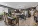 Open-concept kitchen with stainless steel appliances, dark cabinetry, and an island with bar seating at 5831 N 196Th Ln, Litchfield Park, AZ 85340