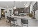 Open kitchen with bar seating, granite countertops, and stainless steel appliances at 5831 N 196Th Ln, Litchfield Park, AZ 85340