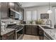 Beautiful kitchen with granite countertops, modern appliances, and decorative accents at 5831 N 196Th Ln, Litchfield Park, AZ 85340