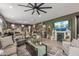Open-concept living area with a fireplace, tv, and connected kitchen creates the perfect space for entertaining at 5831 N 196Th Ln, Litchfield Park, AZ 85340