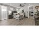 This is a well-lit main bedroom with wood flooring, decorations, and an ensuite bathroom and exercise room at 5831 N 196Th Ln, Litchfield Park, AZ 85340