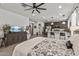 An open-concept main bedroom with kitchen appliances, and a laundry room visible from the foot of the bed at 5831 N 196Th Ln, Litchfield Park, AZ 85340