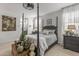 Serene main bedroom featuring a four-poster bed, soft lighting, and access to an ensuite bathroom at 5831 N 196Th Ln, Litchfield Park, AZ 85340