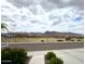 Scenic street view showcases a well-maintained street with mountain views and lush greenery, offering a tranquil neighborhood at 5831 N 196Th Ln, Litchfield Park, AZ 85340