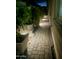 Cozy walkway with stone pavers and landscape lighting highlights the manicured plantings at 5831 N 196Th Ln, Litchfield Park, AZ 85340