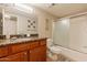 Modern bathroom features granite countertops, wood cabinets, and a shower-tub combo at 5877 N Granite Reef Rd # 1145, Scottsdale, AZ 85250