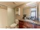 Modern bathroom features granite countertops, wood cabinets, and a glass-enclosed shower at 5877 N Granite Reef Rd # 1145, Scottsdale, AZ 85250