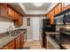 This kitchen has stainless steel appliances, tile countertops, wooden cabinets and laminate flooring at 5877 N Granite Reef Rd # 1145, Scottsdale, AZ 85250
