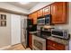 Well-equipped kitchen with stainless steel appliances, granite countertops and wooden cabinets at 5877 N Granite Reef Rd # 1145, Scottsdale, AZ 85250