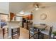 Eat-in kitchen with wood cabinets, black appliances, and adjacent dining area at 5877 N Granite Reef Rd # 1145, Scottsdale, AZ 85250