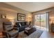 Comfortable living room with cozy seating, area rug, and sliding glass doors to patio at 5877 N Granite Reef Rd # 1145, Scottsdale, AZ 85250