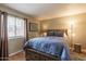 Comfortable main bedroom features wood floors, a large window, and neutral colors at 5877 N Granite Reef Rd # 1145, Scottsdale, AZ 85250