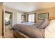 Comfortable main bedroom features wood floors, neutral colors, and easy access to the living room at 5877 N Granite Reef Rd # 1145, Scottsdale, AZ 85250