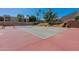 Well-maintained tennis court surrounded by mature trees and lush landscaping, ideal for recreational activities at 5877 N Granite Reef Rd # 1145, Scottsdale, AZ 85250