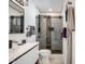 Modern bathroom with a glass-enclosed shower, updated vanity, and sleek black fixtures at 6326 N 86Th N St, Scottsdale, AZ 85250