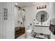 Bathroom features a vanity, black framed mirror, enclosed glass shower, and modern lighting at 6326 N 86Th N St, Scottsdale, AZ 85250