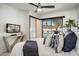 This bedroom offers a ceiling fan, TV, console table, and outdoor pool views at 6326 N 86Th N St, Scottsdale, AZ 85250