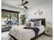 Bright bedroom featuring a ceiling fan and sliding glass doors to the outdoor seating area at 6326 N 86Th N St, Scottsdale, AZ 85250