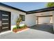 Home exterior featuring a carport, flower bed, and modern door at 6326 N 86Th N St, Scottsdale, AZ 85250