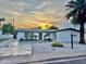 Charming single-story home with modern updates and a well-maintained front yard, set against a beautiful sunset backdrop at 6326 N 86Th N St, Scottsdale, AZ 85250