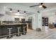 Modern kitchen has stainless steel appliances, white cabinets, a tile backsplash, and a bar at 6326 N 86Th N St, Scottsdale, AZ 85250