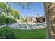 Lush backyard showcasing a sparkling pool, lounge seating and an outdoor living space at 7278 E Echo Ln, Scottsdale, AZ 85258