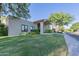 Charming single-story home with a well-manicured lawn, mature landscaping, and covered porch at 7278 E Echo Ln, Scottsdale, AZ 85258