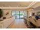 Spacious living room featuring a modern dining area, stylish decor, and sliding doors that open to the outdoor pool area at 7278 E Echo Ln, Scottsdale, AZ 85258