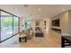 Cozy living room featuring a fireplace, TV, and sliding glass doors opening to an outdoor pool at 7278 E Echo Ln, Scottsdale, AZ 85258