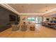 Open living room with fireplace, modern lighting, dining area and view of the outdoor pool at 7278 E Echo Ln, Scottsdale, AZ 85258