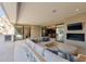 Expansive covered patio with comfortable seating, outdoor fireplace, and seamless transition to the interior living spaces at 7278 E Echo Ln, Scottsdale, AZ 85258