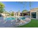 Gorgeous backyard pool area featuring lounge chairs, modern landscaping, and convenient outdoor grilling station at 7278 E Echo Ln, Scottsdale, AZ 85258