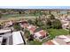 Aerial image showcasing red-roofed buildings surrounded by lush greenery, water features, and a sprawling golf course at 7312 N Via Camello Del Norte St # 95, Scottsdale, AZ 85258