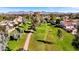 Scenic aerial view of a verdant park pathway lined with trees and charming homes, mountain views in the distance at 7312 N Via Camello Del Norte St # 95, Scottsdale, AZ 85258