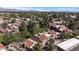 Aerial view showcasing residential buildings with terracotta roofs amidst green lawns, trees, and neighborhood streets at 7312 N Via Camello Del Norte St # 95, Scottsdale, AZ 85258