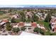 Aerial view of residential buildings with red roofs, green spaces, and a golf course, set against a mountain backdrop at 7312 N Via Camello Del Norte St # 95, Scottsdale, AZ 85258
