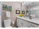 Bright bathroom featuring a white vanity, framed mirror, decorative artwork, and a glass-enclosed shower with white subway tile at 7312 N Via Camello Del Norte St # 95, Scottsdale, AZ 85258