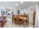 Open dining area features a solid wood table with seating for eight, alongside sleek tile flooring and soft natural light at 7312 N Via Camello Del Norte St # 95, Scottsdale, AZ 85258