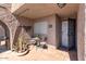 Inviting front porch with red tile, stylish metal lizards, and a cozy table and chairs for outdoor enjoyment at 7312 N Via Camello Del Norte St # 95, Scottsdale, AZ 85258